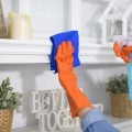 A woman with cleaning gloves using alcohol spray sanitiser to cleaning house, healthy and medical, covid-19 protection at home concept .